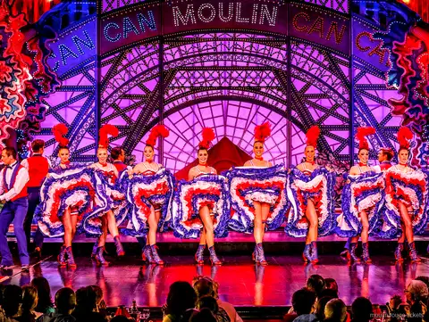 Cancandanseres in een spagaatsprong met blauwe ruches rok en partner, Moulin Rouge dinner show kaarten